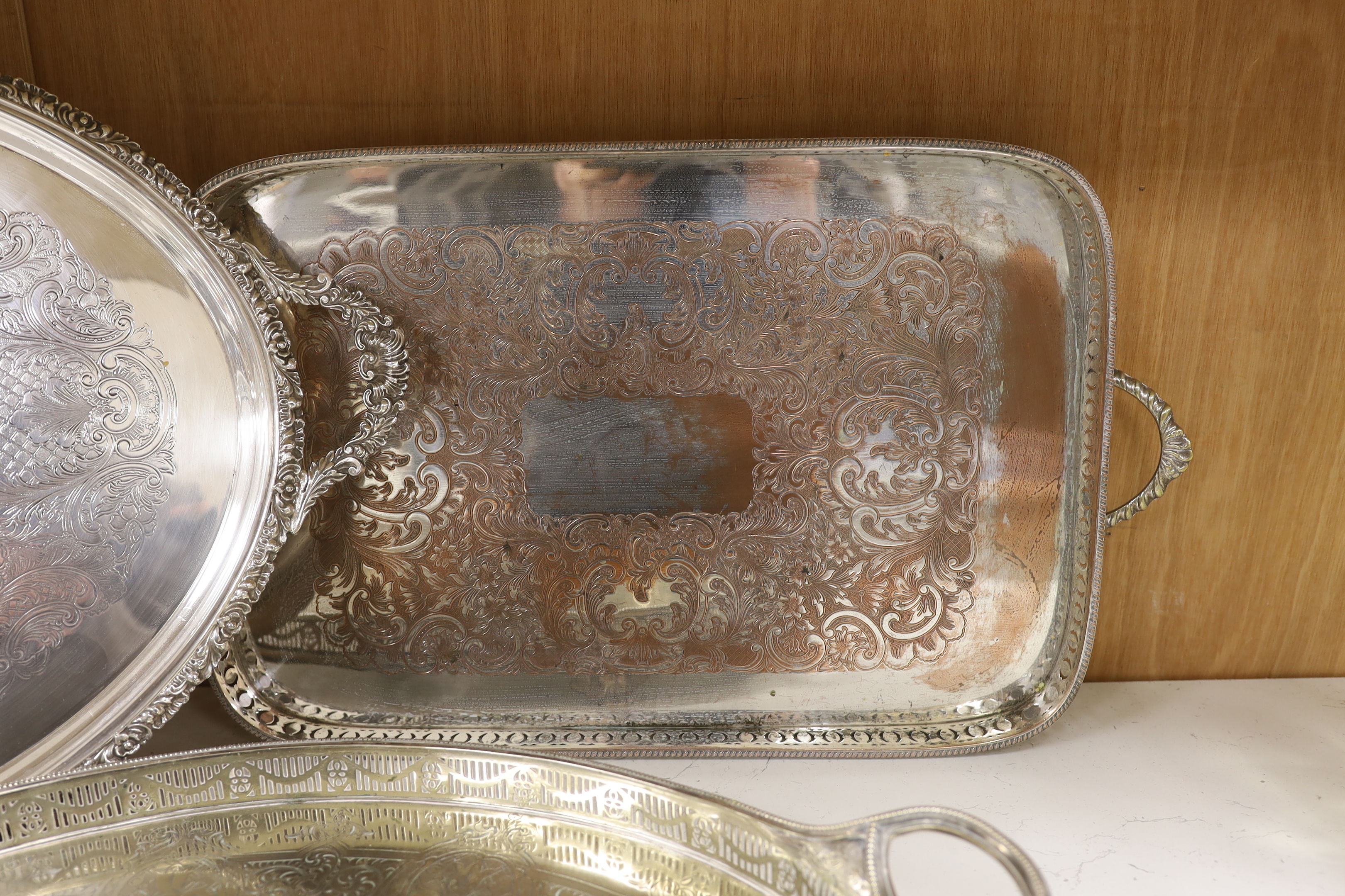 Four items of plated wares; a Victorian galleried tray, a soup tureen and two other trays, largest tray 67cm